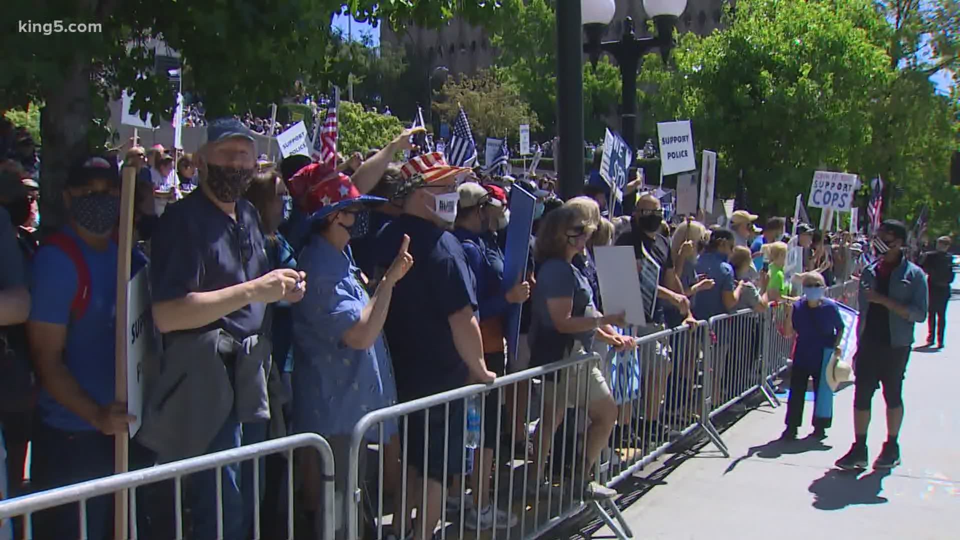 Groups showing support of law enforcement and those protesting against police brutality gathered outside Seattle City Hall.