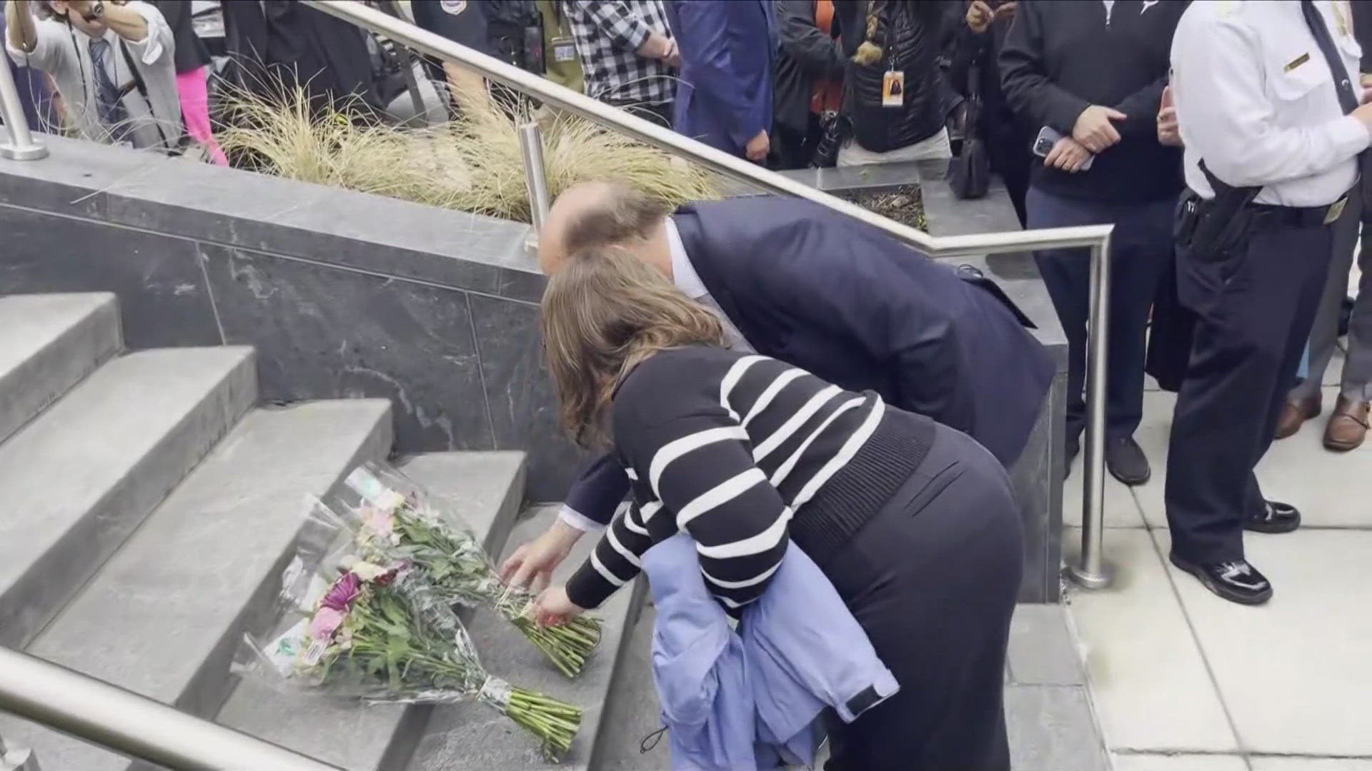 A vigil begins to grow outside the museum with people leaving handwritten notes, flowers and candles for the victims