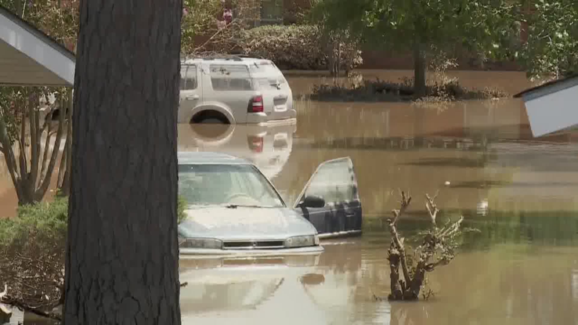 Katie Moore talks to officials, many of whom are flooding victims themselves.