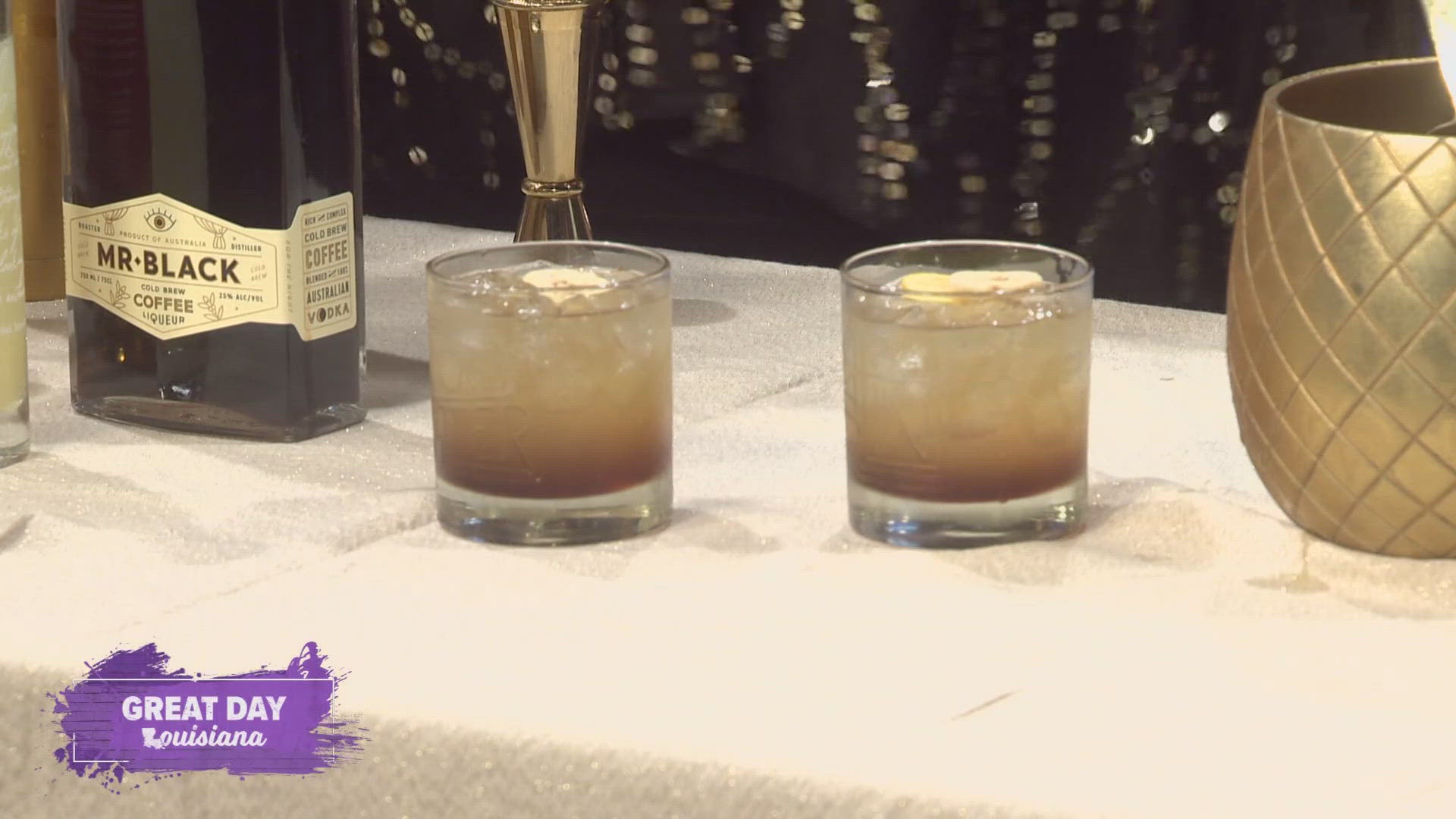 Abigail Gullo mixes up a black and gold themed cocktail for tonight's Saints' game.