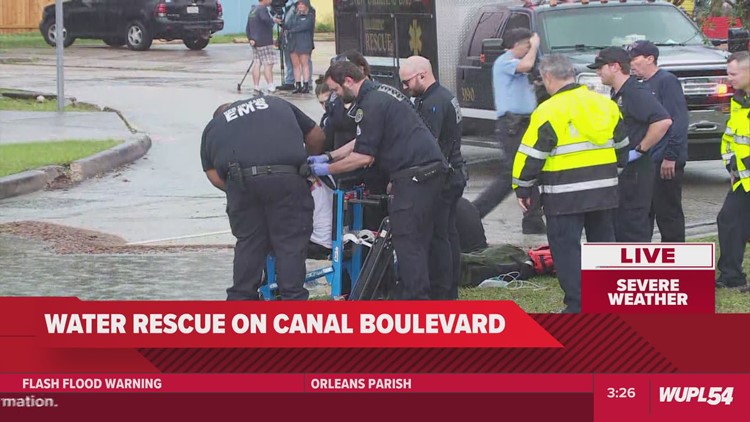 Two men rescued from car during street flooding on Canal Blvd.
