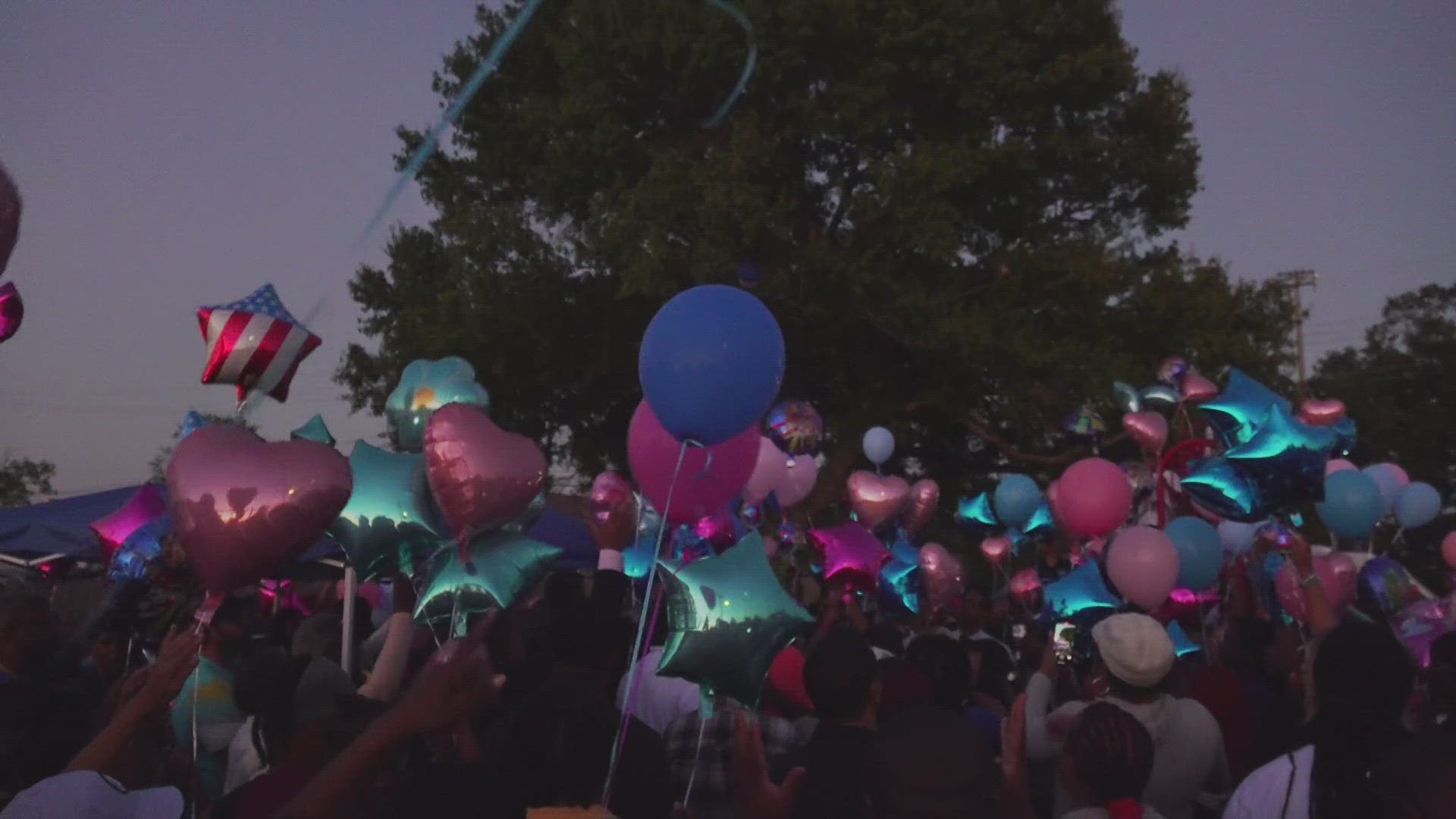 Hundreds attend a vigil to remember three children who died in a house fire.