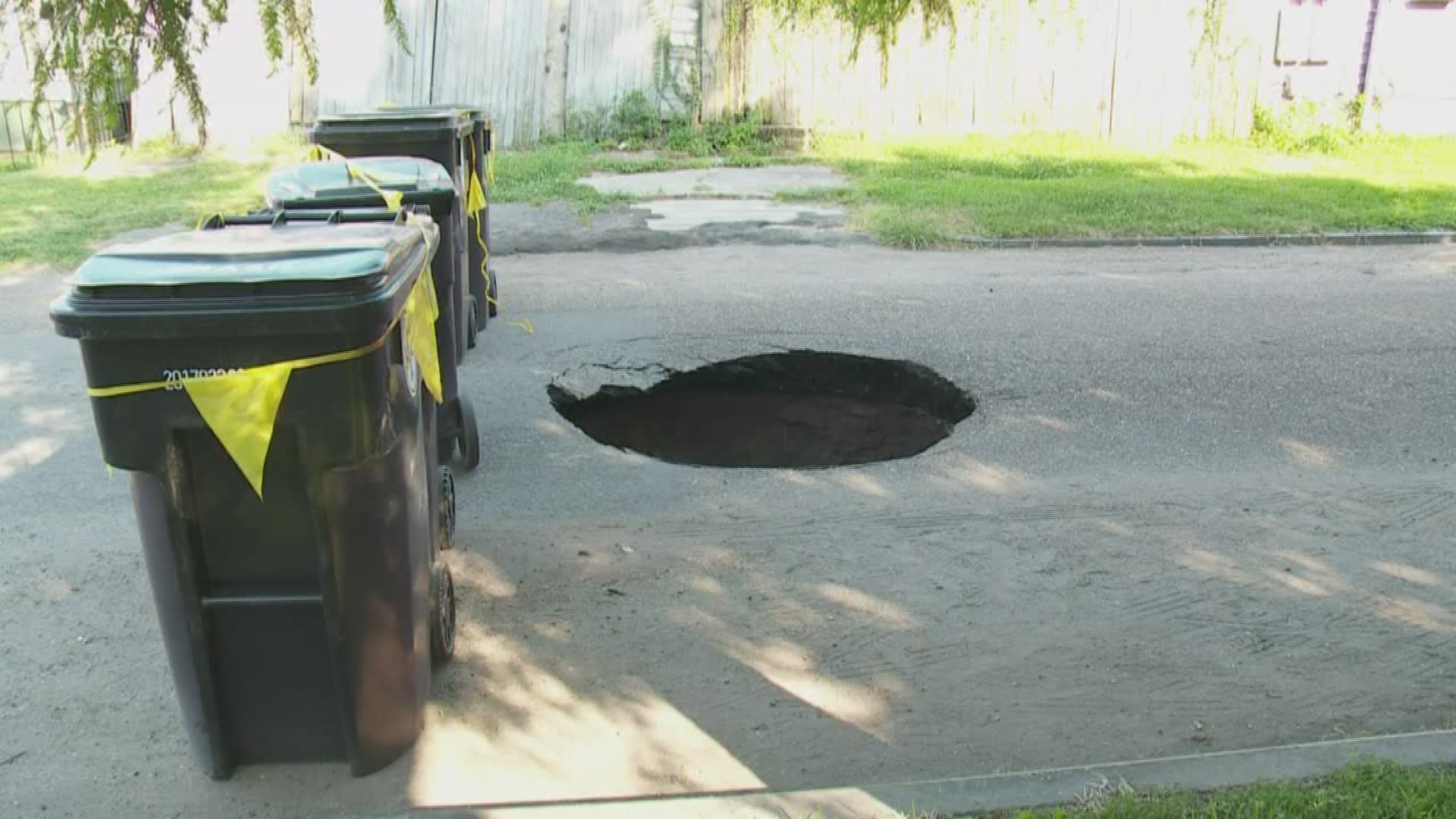 A large hole opened up in the the middle of an Uptown street Sunday, making the road impassable for cars and leaving residents worried ahead of the work week.