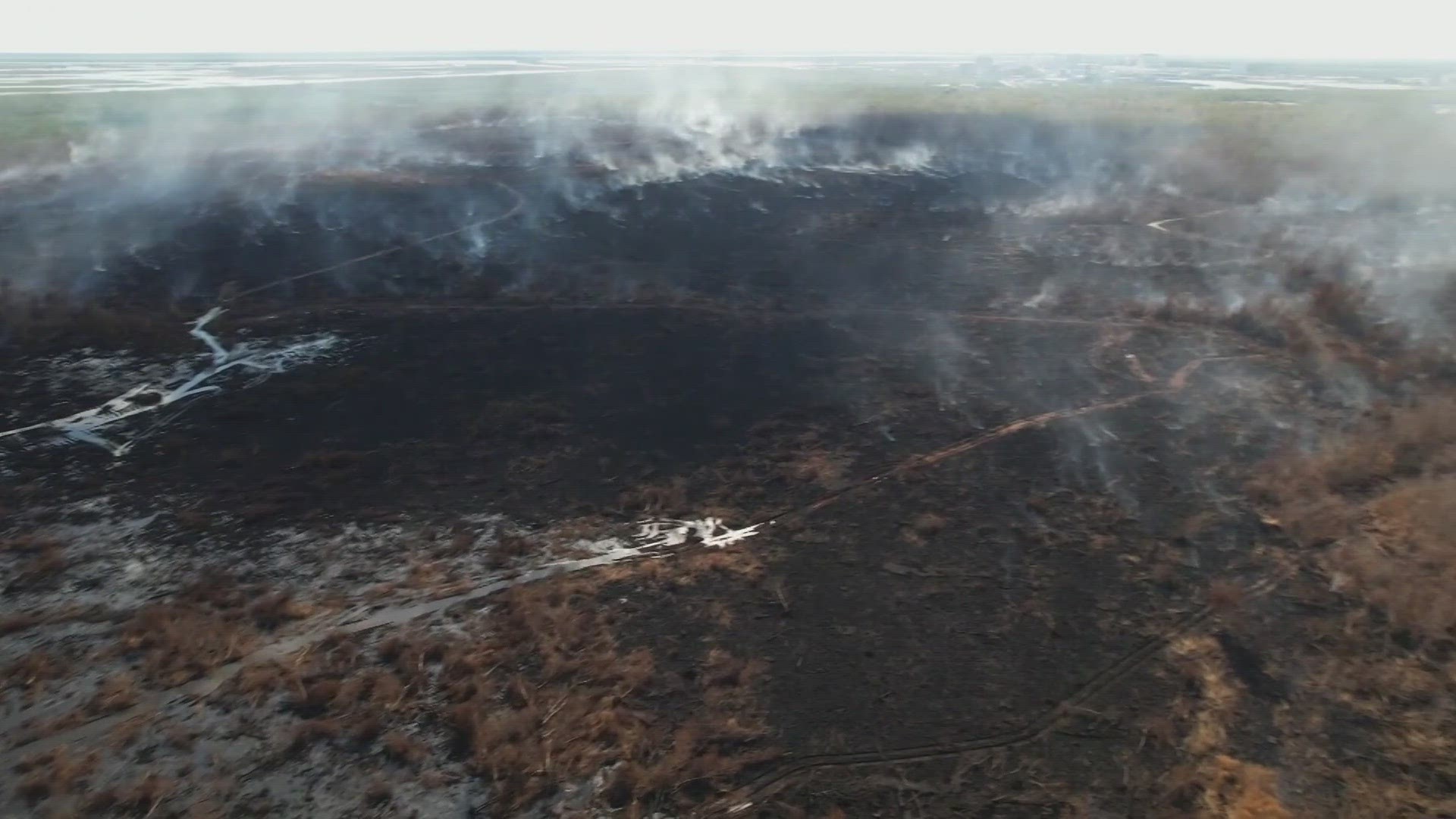 The New Orleans East marsh fire has been burning for more than three weeks now, but this drizzle is making a difference.