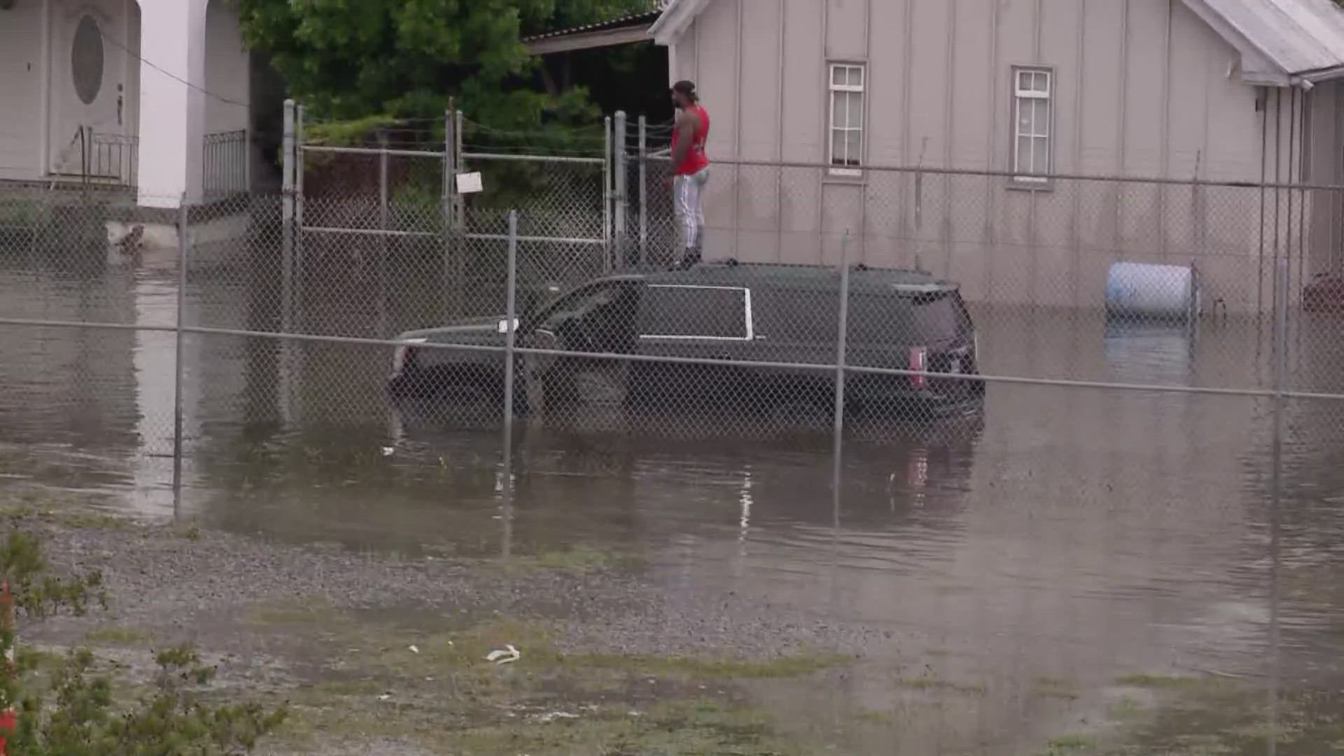 Around 4:30 p.m., a man in a tall SUV drove through really deep floodwaters. He ended up stalled, and standing on the roof of his car near Airline Drive.