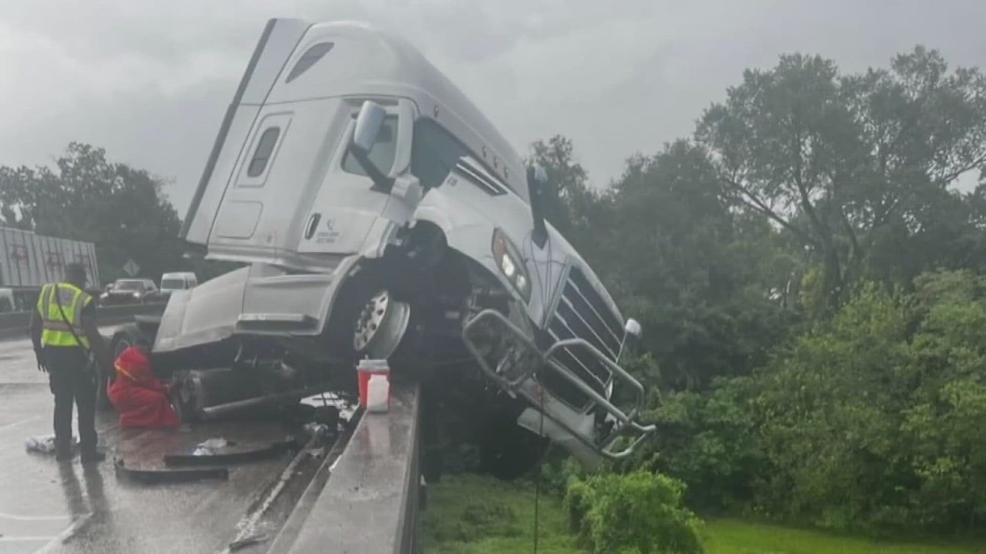 The truck was seen on traffic cameras dangling over the side of the elevated interstate. Traffic was backed up for five miles, according to the DOTD.