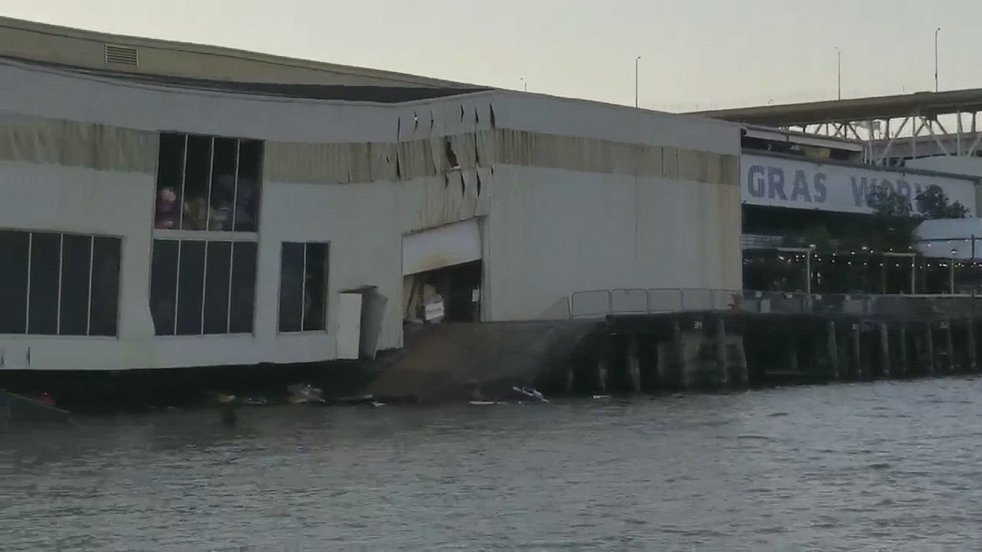 The video shows the side of the building crumpled, and the walkway broken and in the water.