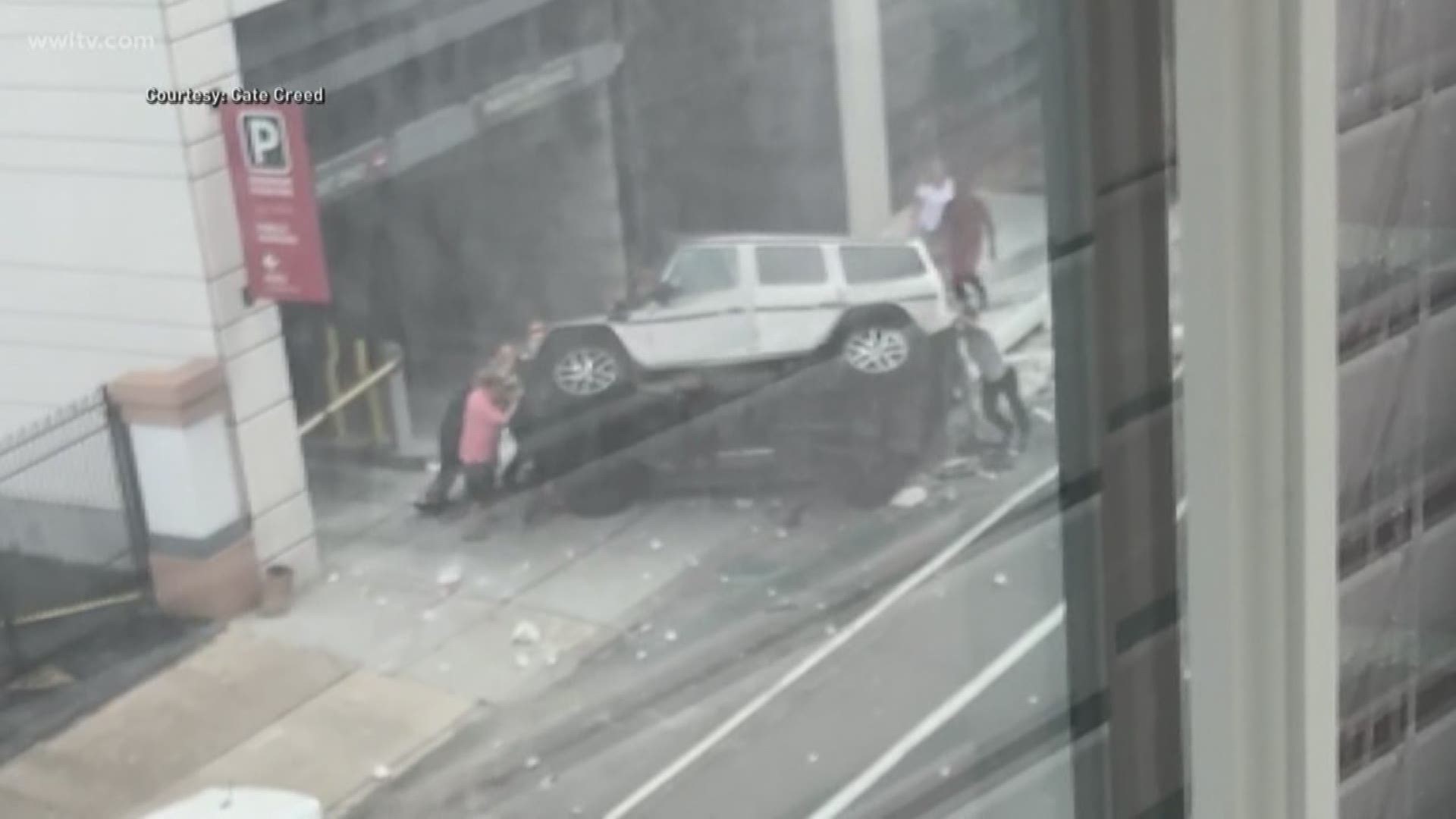 Officials said the driver of a silver Mercedes SUV drove off the fourth floor of the parking garage and landed on the street below.