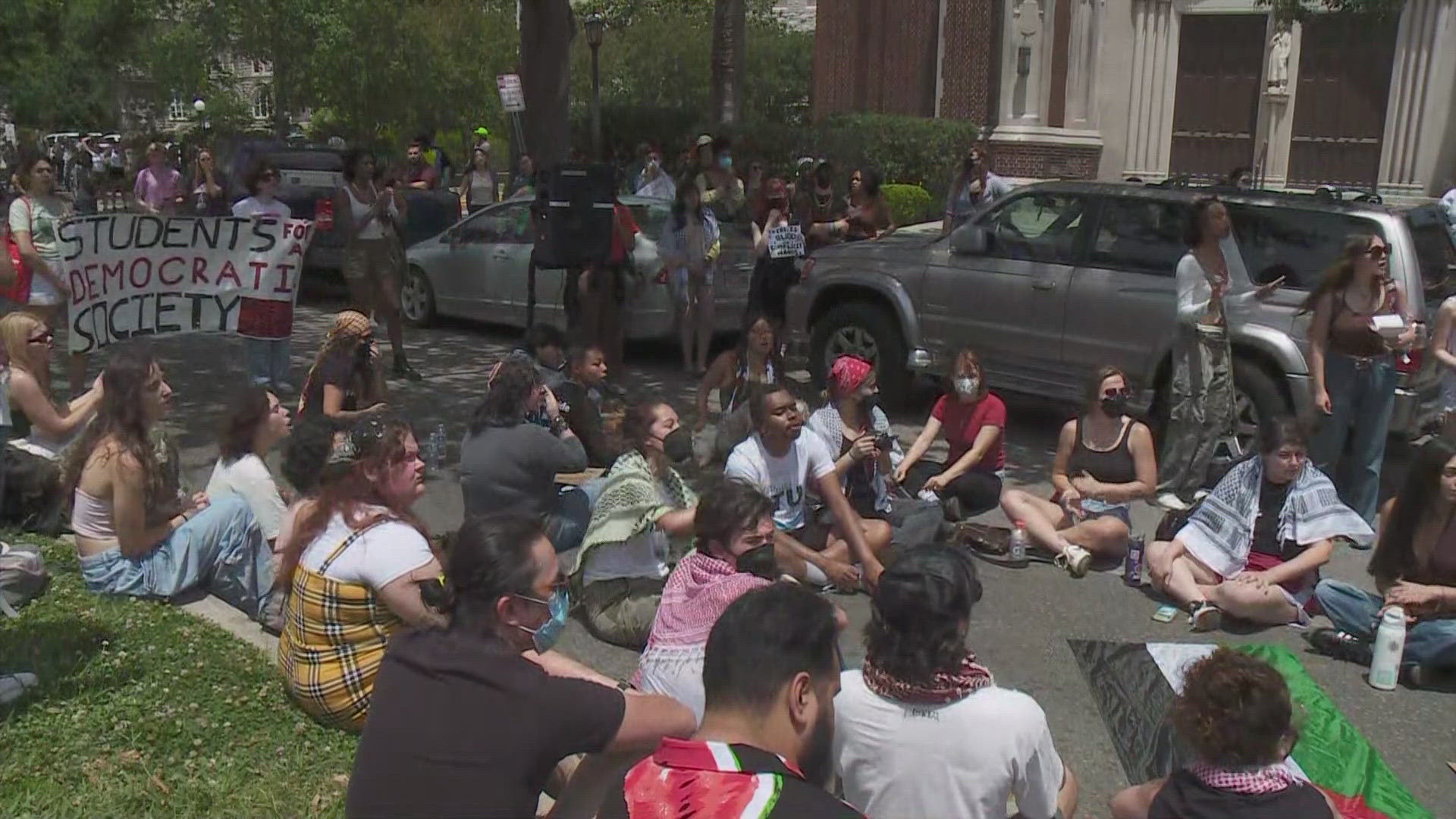 What appeared to be a crowd of more than 100 protesters blocked St. Charles Avenue near the campuses Friday afternoon.