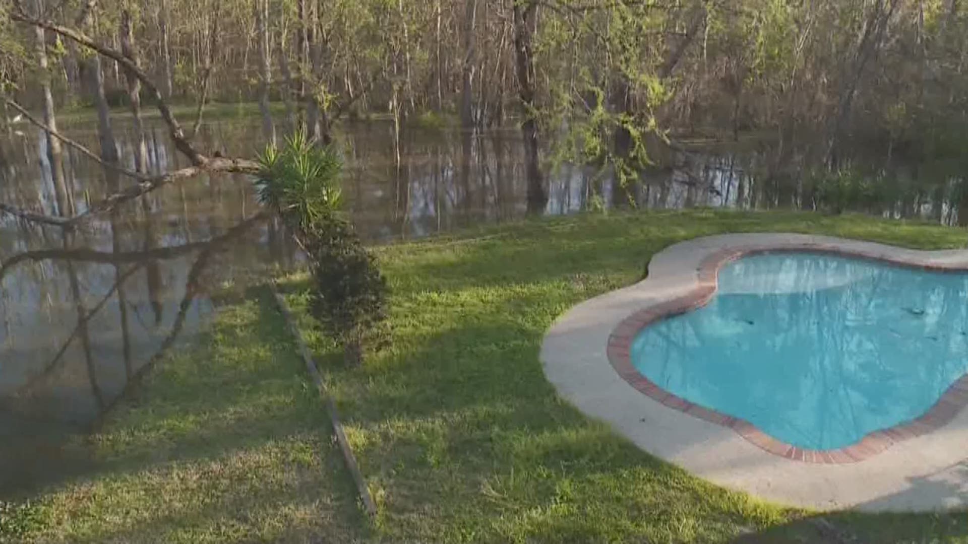 Antwan Harris talks to residents in Slidell who are watching the Pearl River rise.