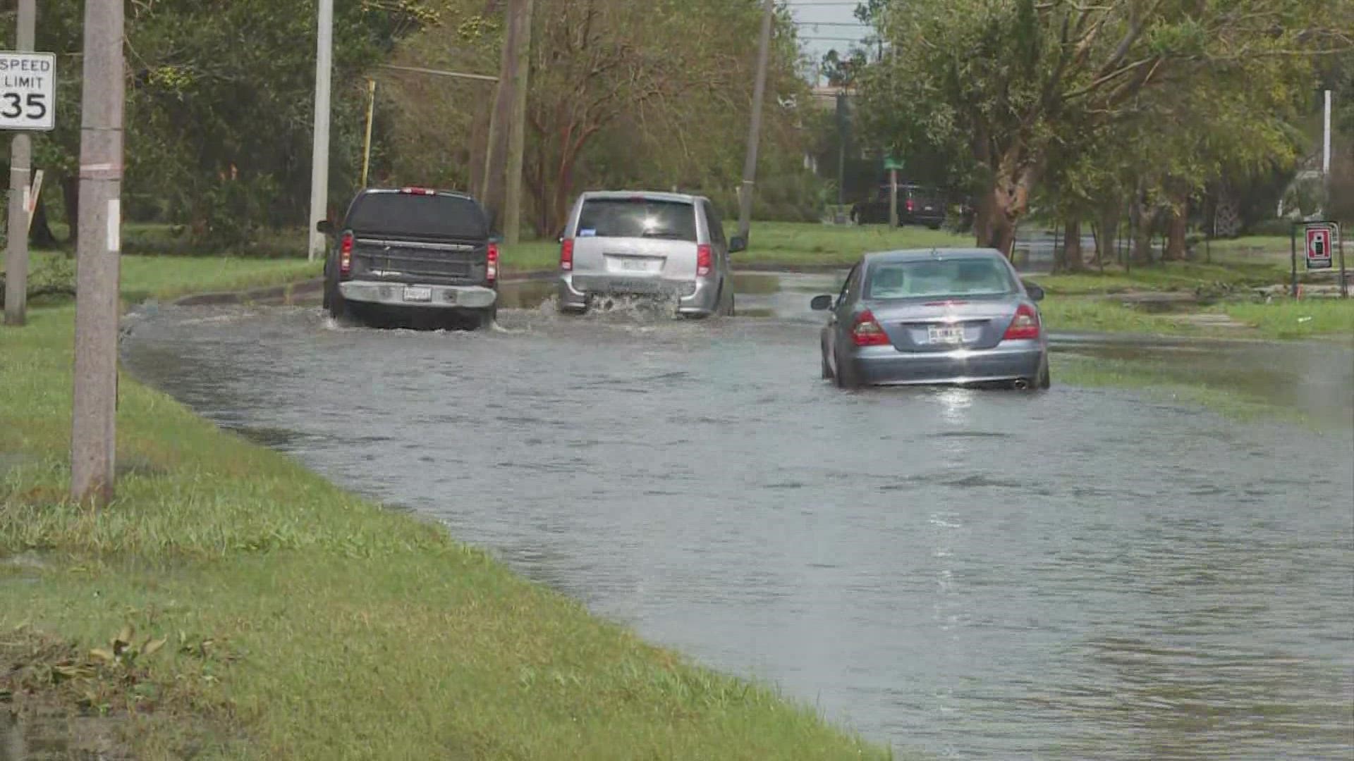 The water in the drainage canal between General De Gaulle Drive's eastbound and westbound lanes has reached the roadway.