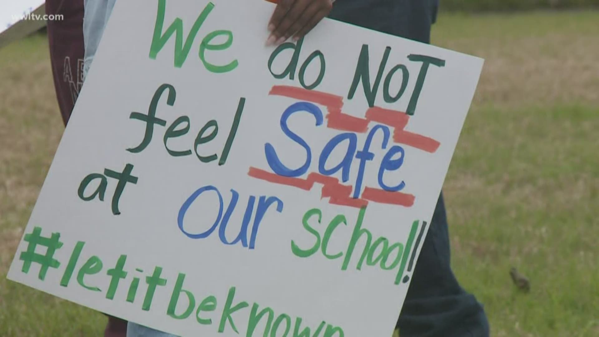 About a dozen parents with signs protested outside of the Einstein Charter campus Monday, saying the school lacks proper safety.