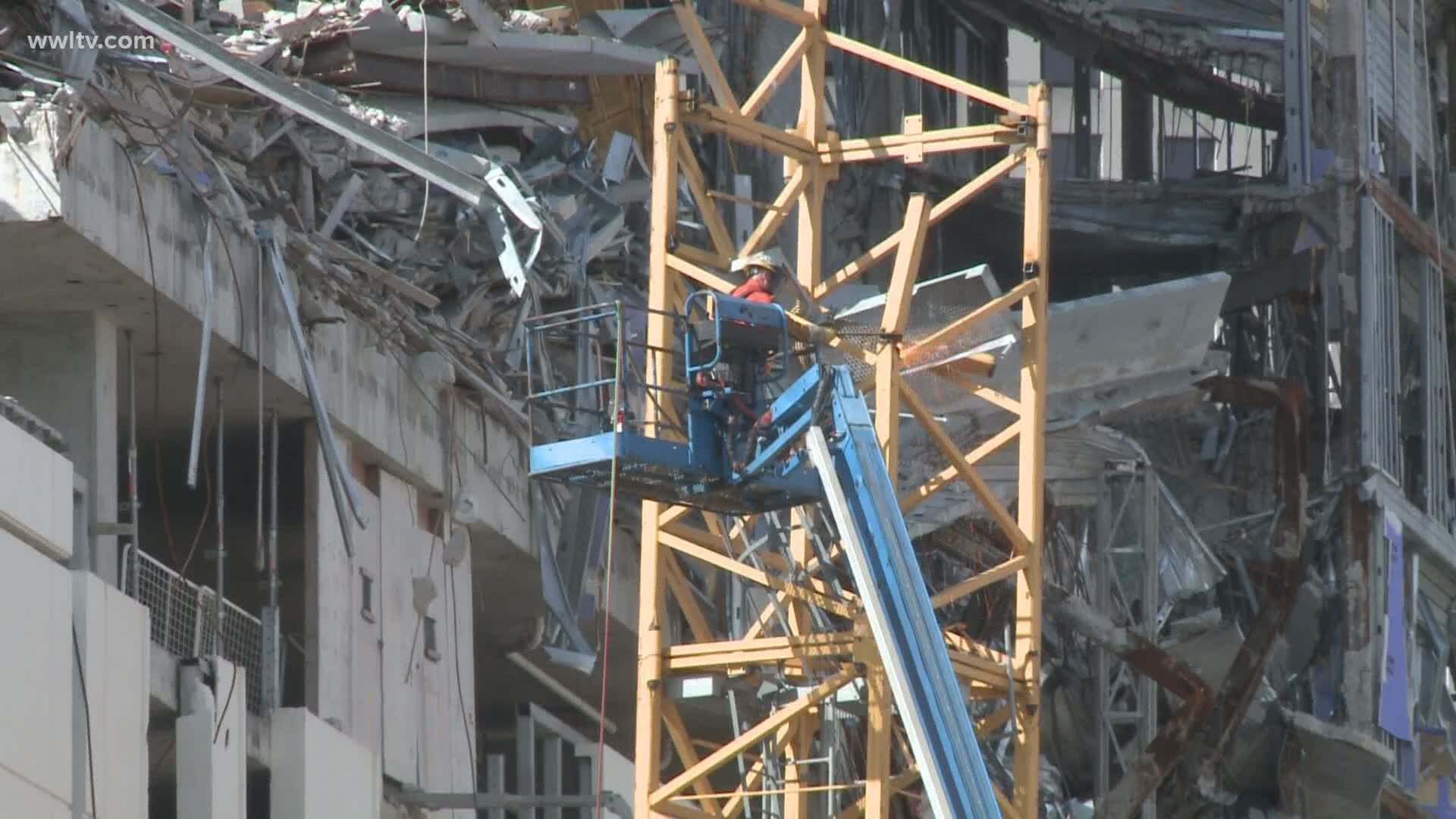 Hard Rock demolition continues on schedule, workers slice into crane impaling Rampart St.