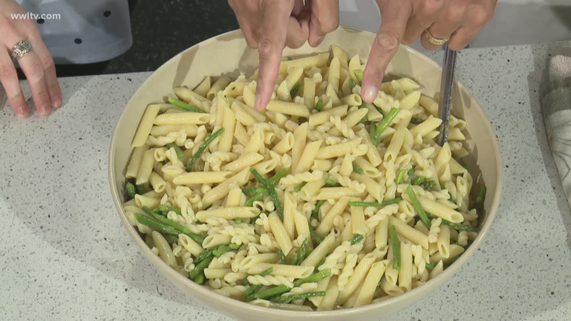 Chef Kevin Belton shows Leslie Spoon how he makes a Pesto Pasta 'al dente.'