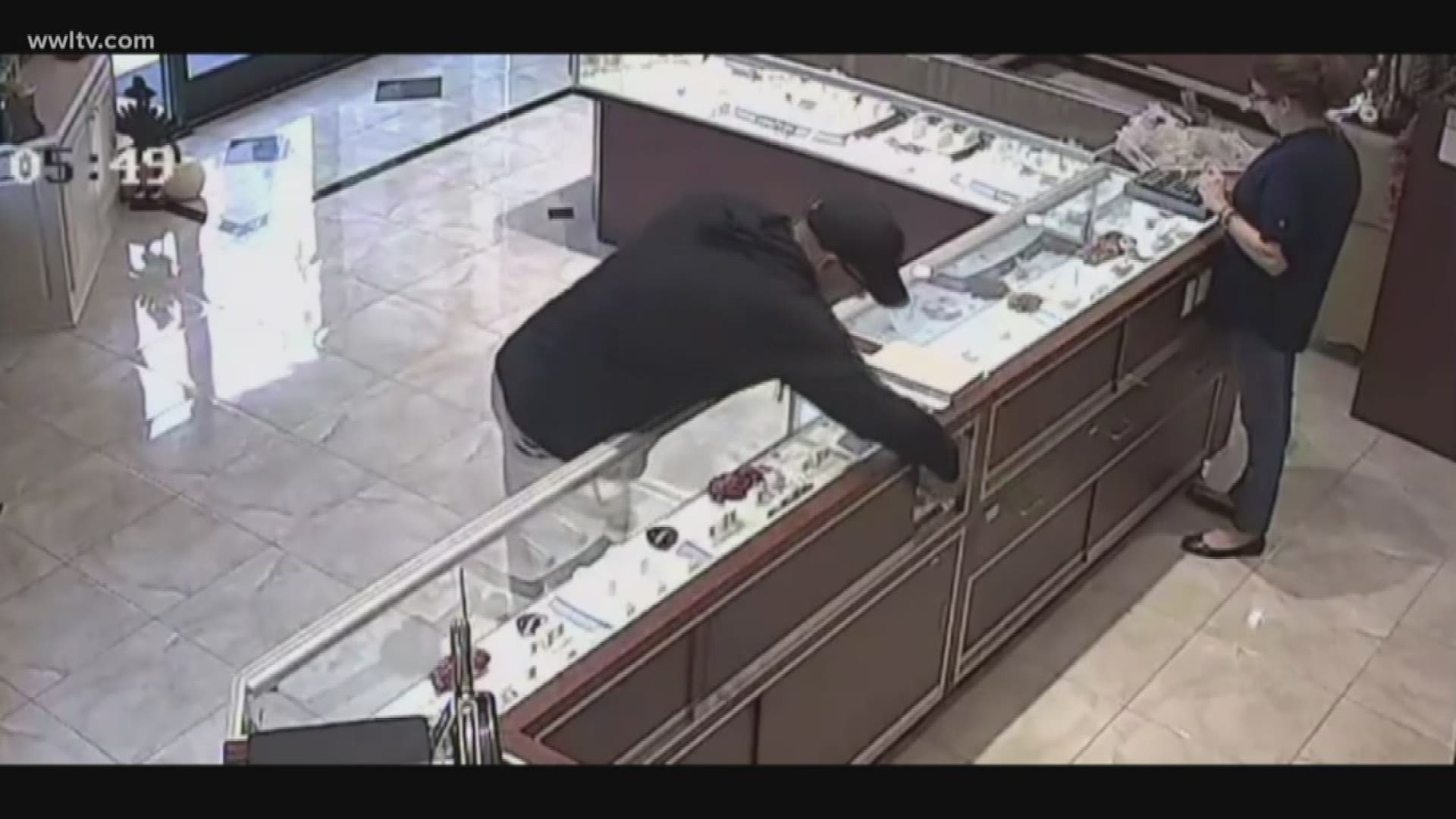 Police are searching for a man caught on camera grabbing $10,000 worth of jewelry out of a Slidell store's display case.