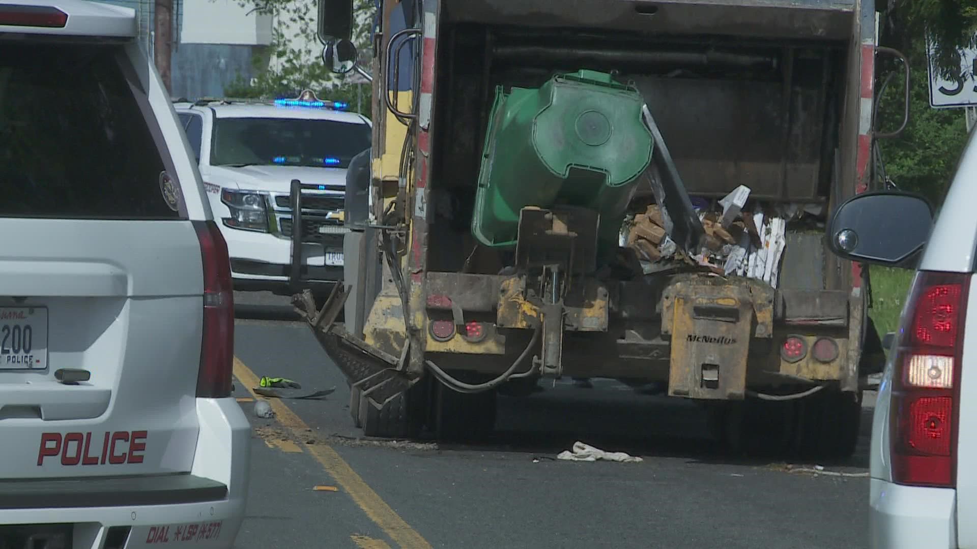 A worker on a trash pickup detail lost his leg when another car pinned him against the garbage truck. Police say the car's driver was texting.