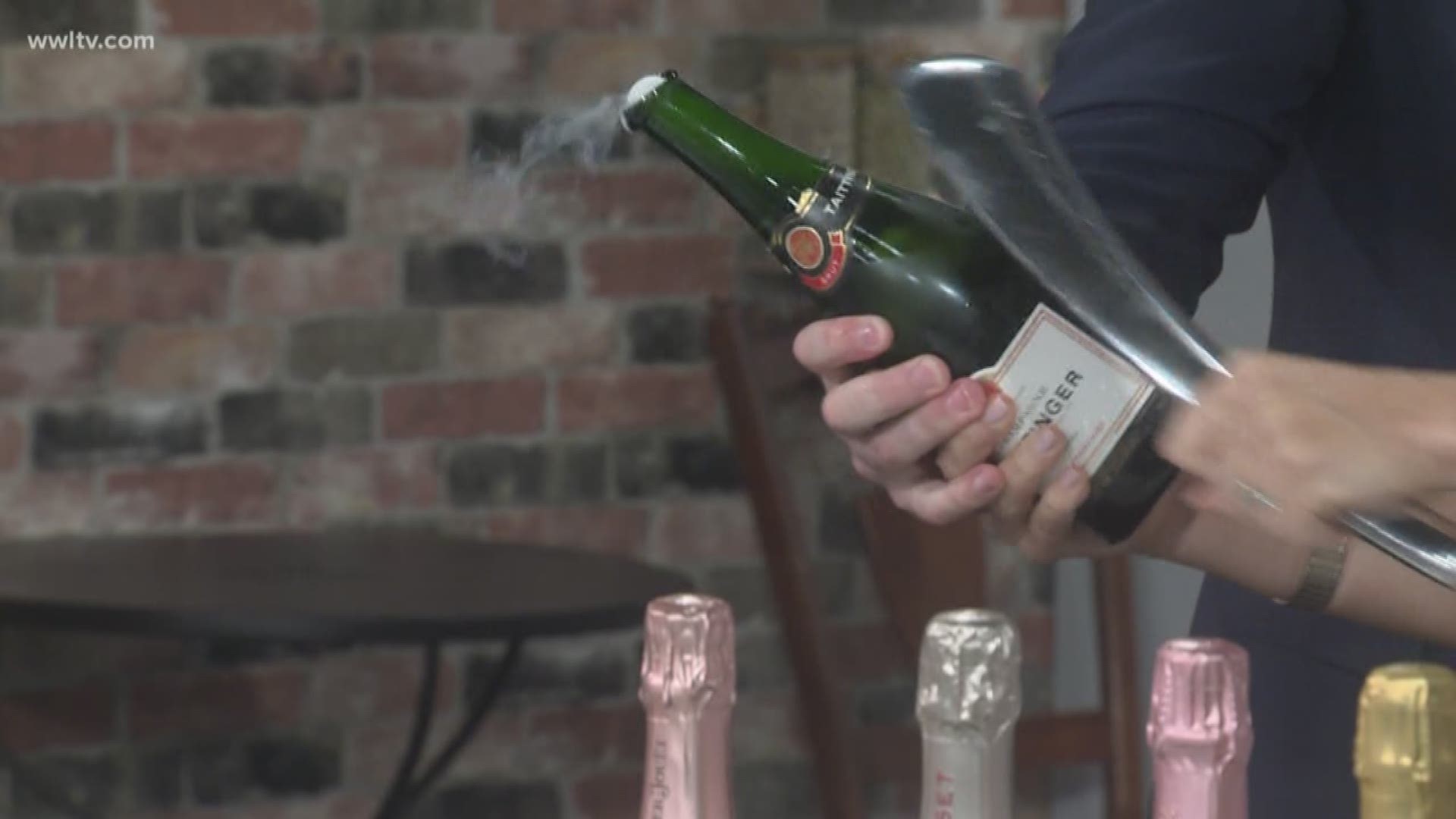 Patrick Brennan with Brennan's Restaurant is showing us how to saber a Champagne bottle in honor of their of their week long Happy Hour.