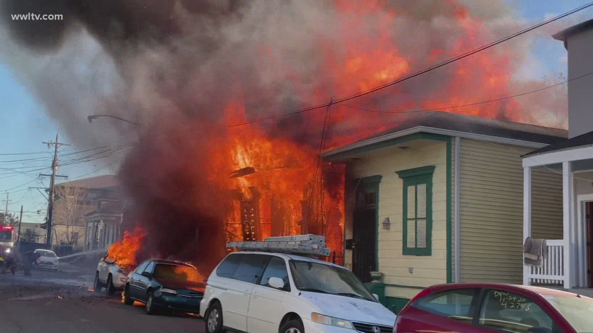 Two people were injured and three buildings were totally destroyed in a three-alarm fire in New Orleans Tuesday.