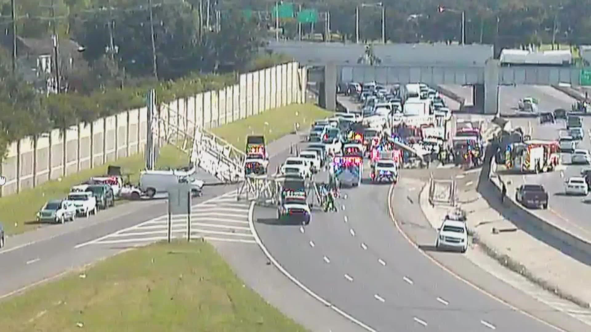 An accident Friday left two people in the hospital after a truck crashed into an interstate sign making it collapse onto the roadway.