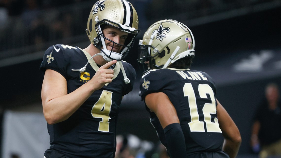 New Orleans Saints first round draft pick, wide receiver Chris Olave (12),  high fives quarterback Jameis