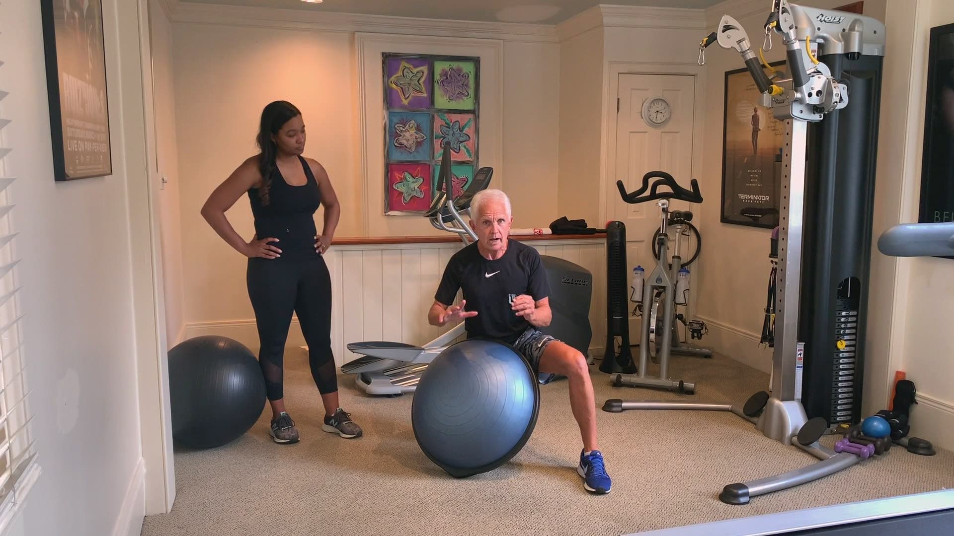 Fitness expert Mackie Shilstone shows April Dupre some tips for exercising in small spaces at home, using what is called a Bosu stability ball.
