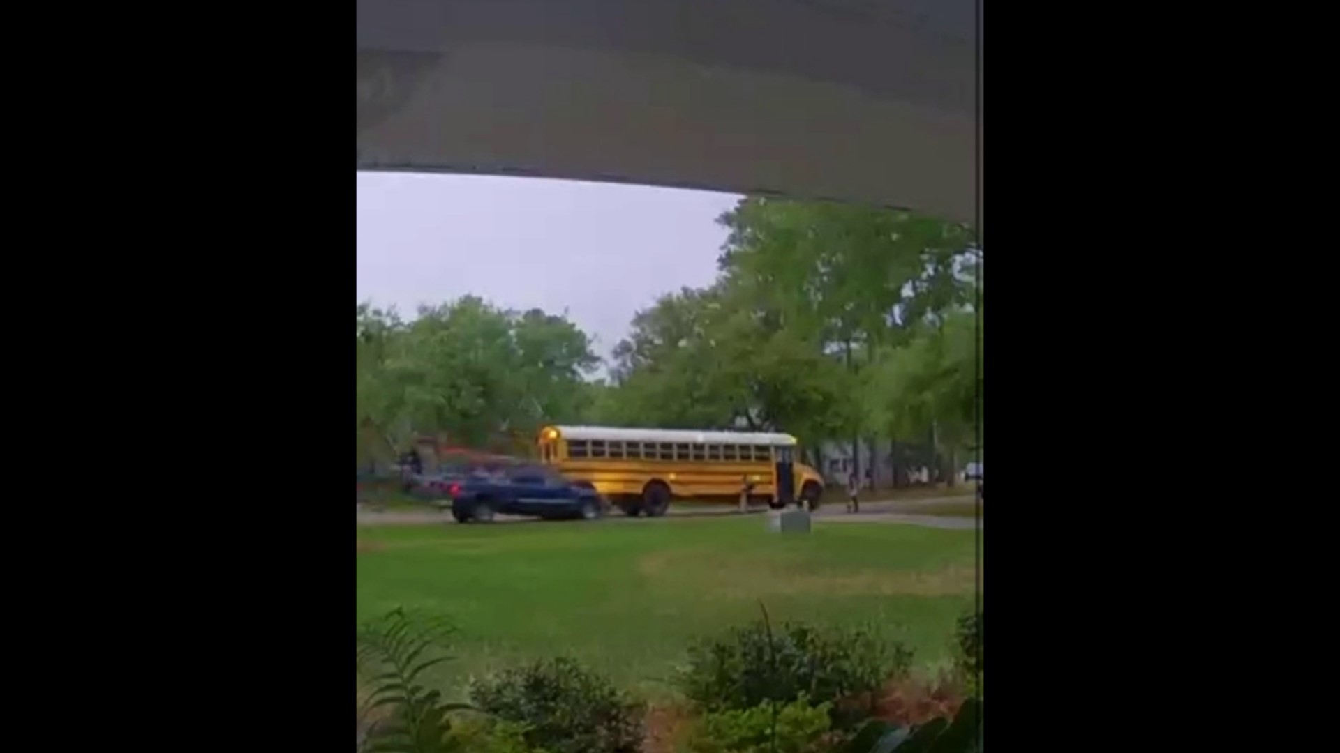 Doorbell camera captures the terrifying moment a pickup crashes into a school bus, child nearby.
