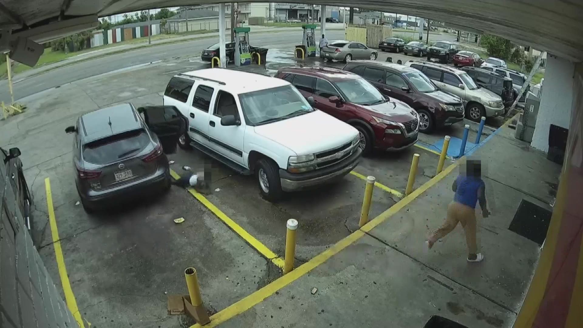 A woman drove off with an SUV from a New Orleans gas station and two children who were inside dove out, rolling over the boy's leg in the process.