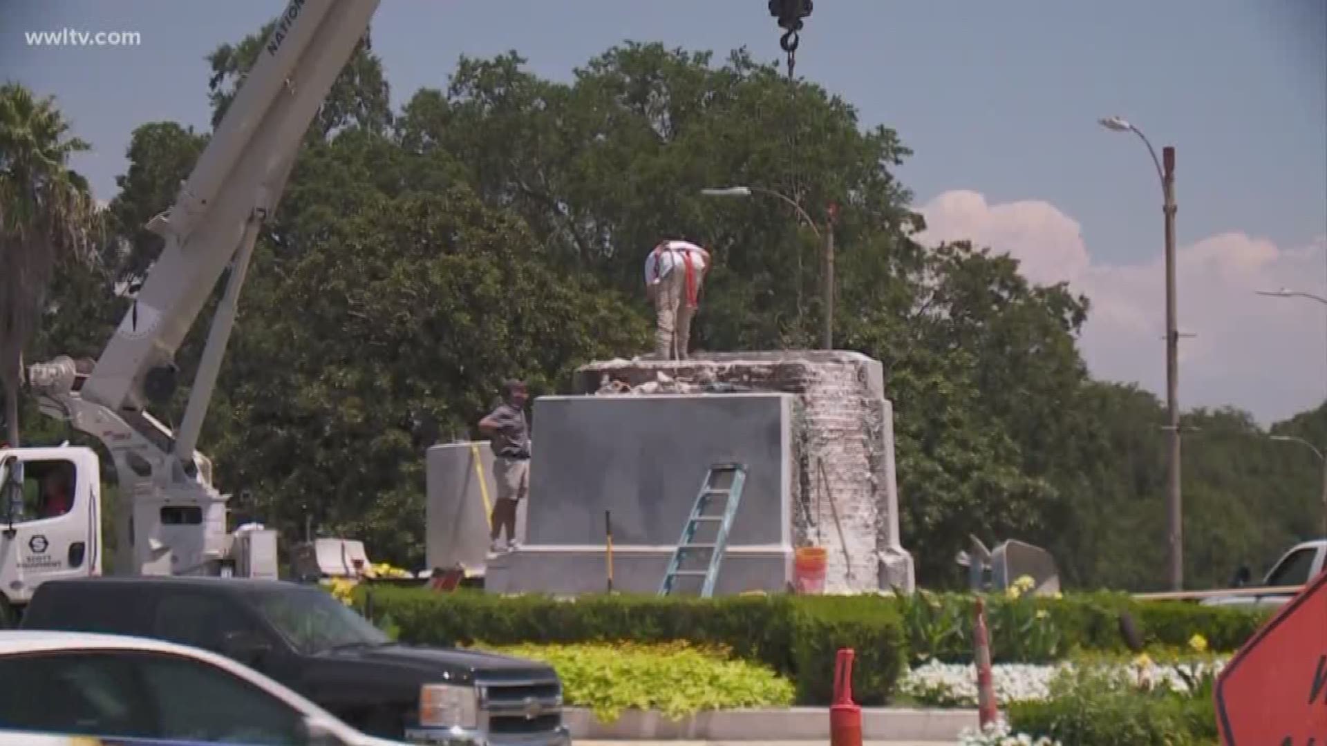 The crew is removing granite from the base as well as a time capsule reportedly placed inside.