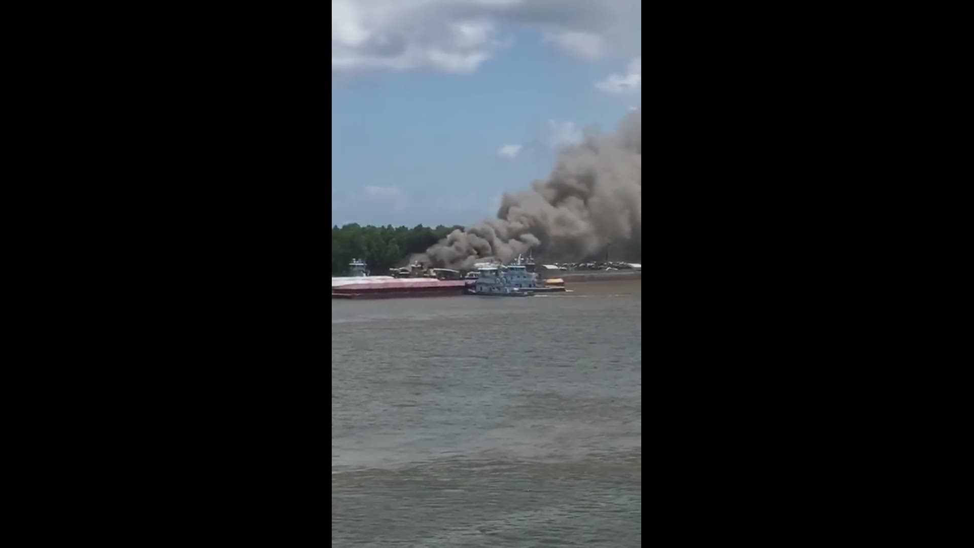 Viewer submitted video shows several scrap cars on a barge on fire.