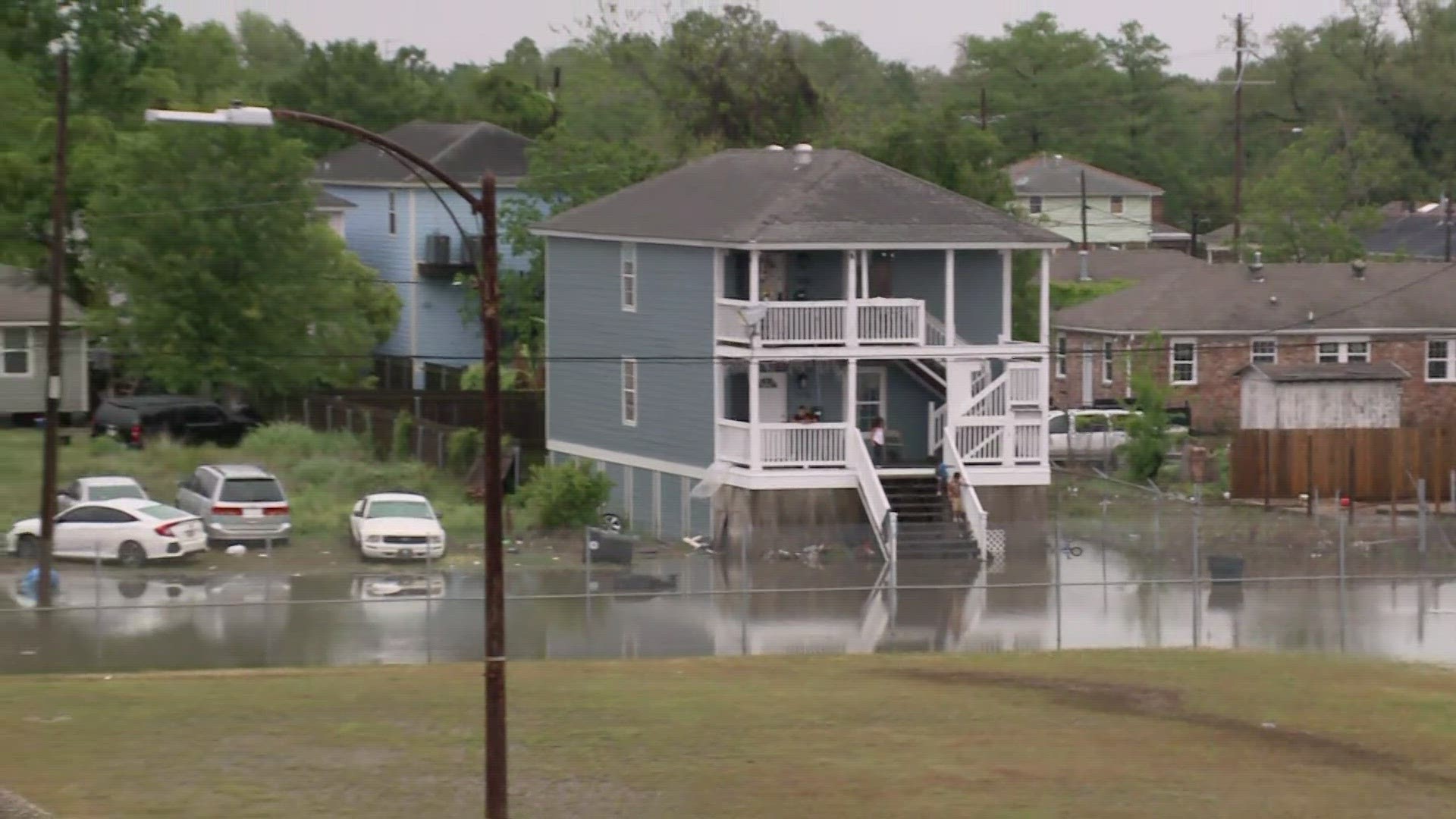 Residents struggle to make it home through flood waters on Airline Drive.