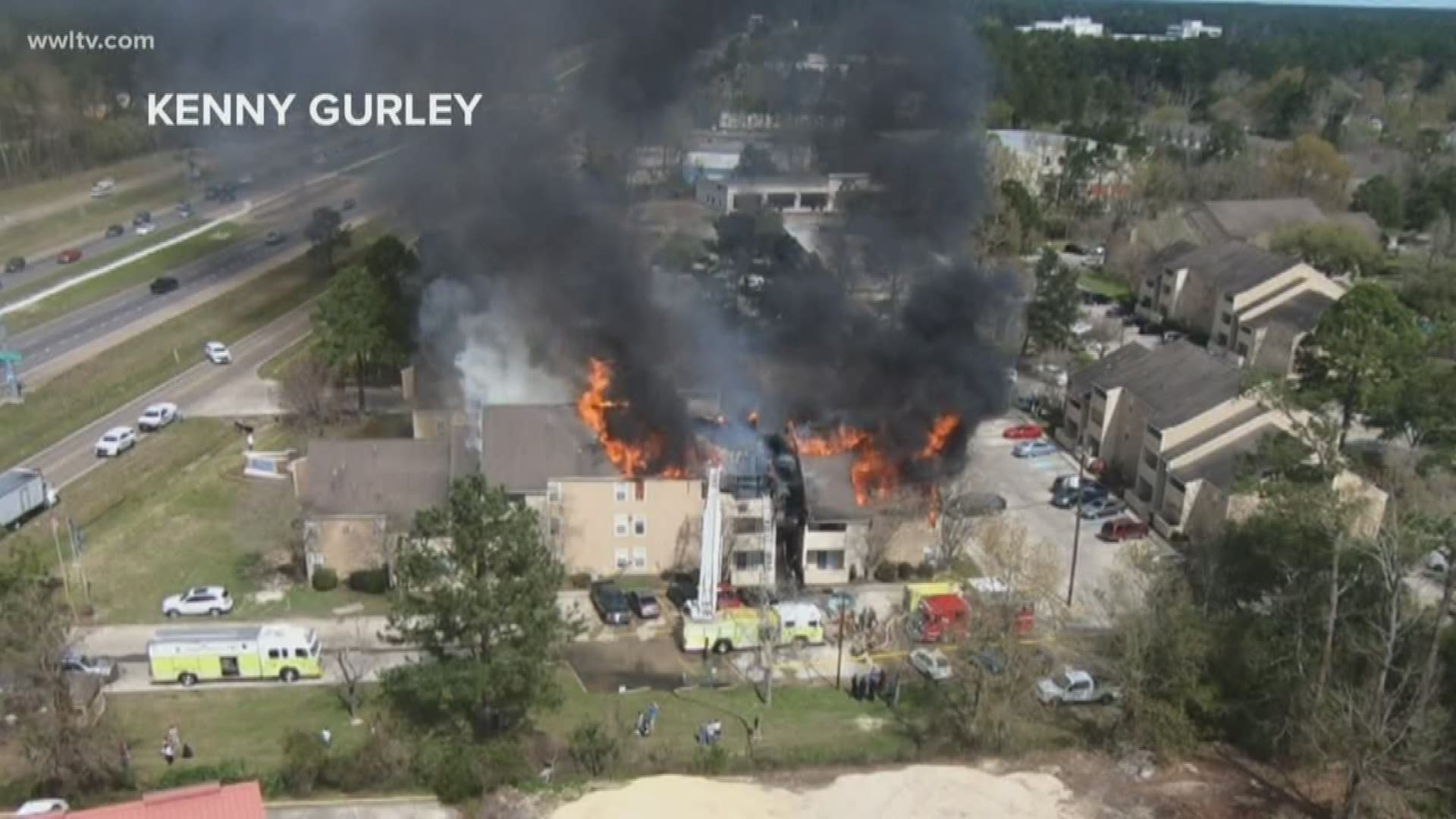 Drone footage show flames and smoke reaching out from the building's rooftop