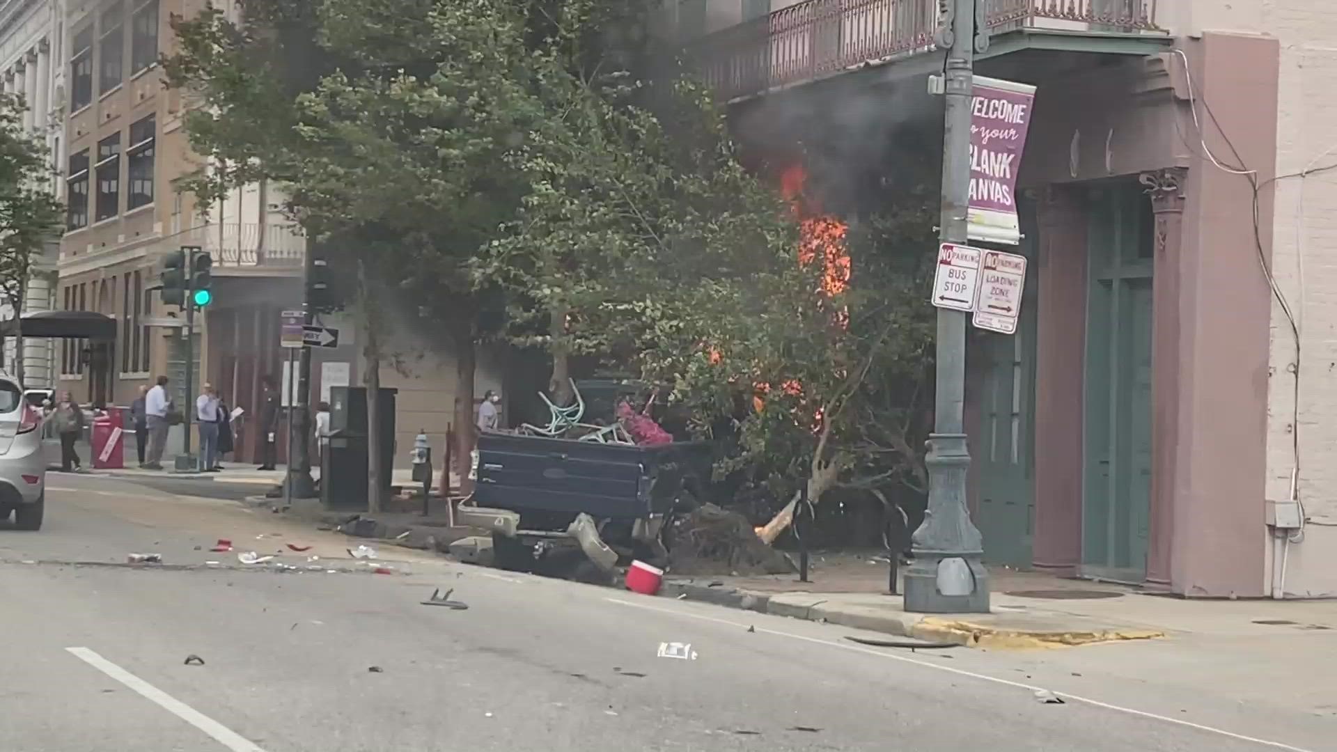 A truck catches fire after crashing into a building in New Orleans Central Business District Thursday.