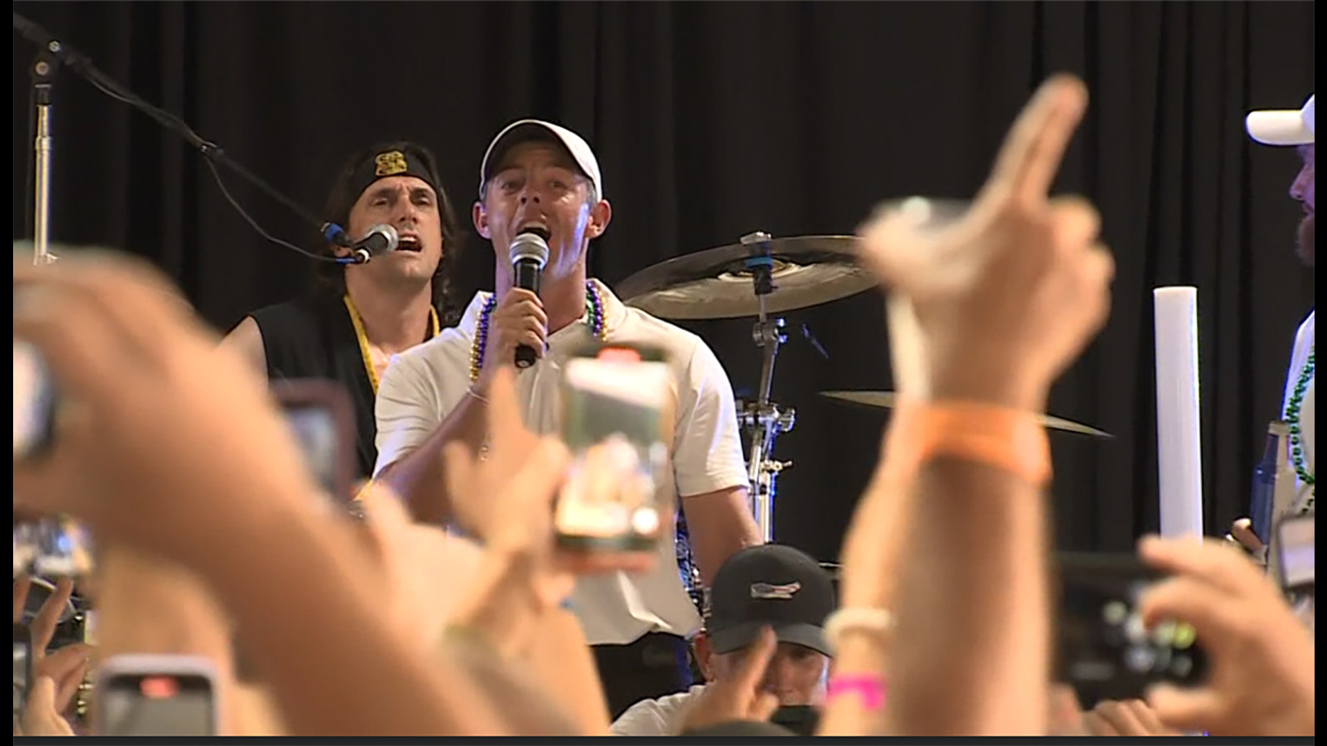 Rory McIlroy, one of the world's best golfers, let his hair down by downing a beer and then belting out a song in front of a raucous crowd in New Orleans.
